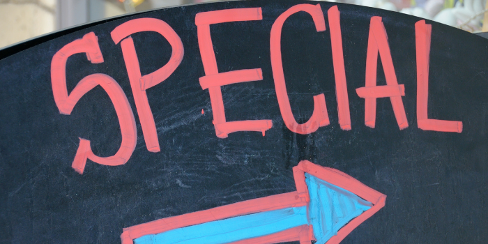 A blackboard sign with "SPECIAL" and an arrow pointing right on it.