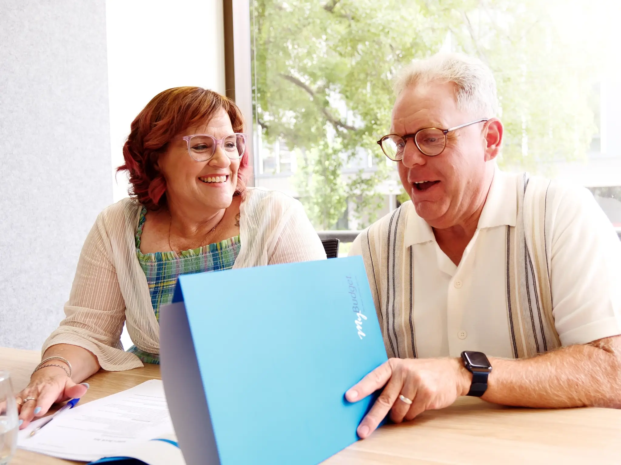 MyBudget clients Michelle and Phil reviewing documents during a free budget appointment.