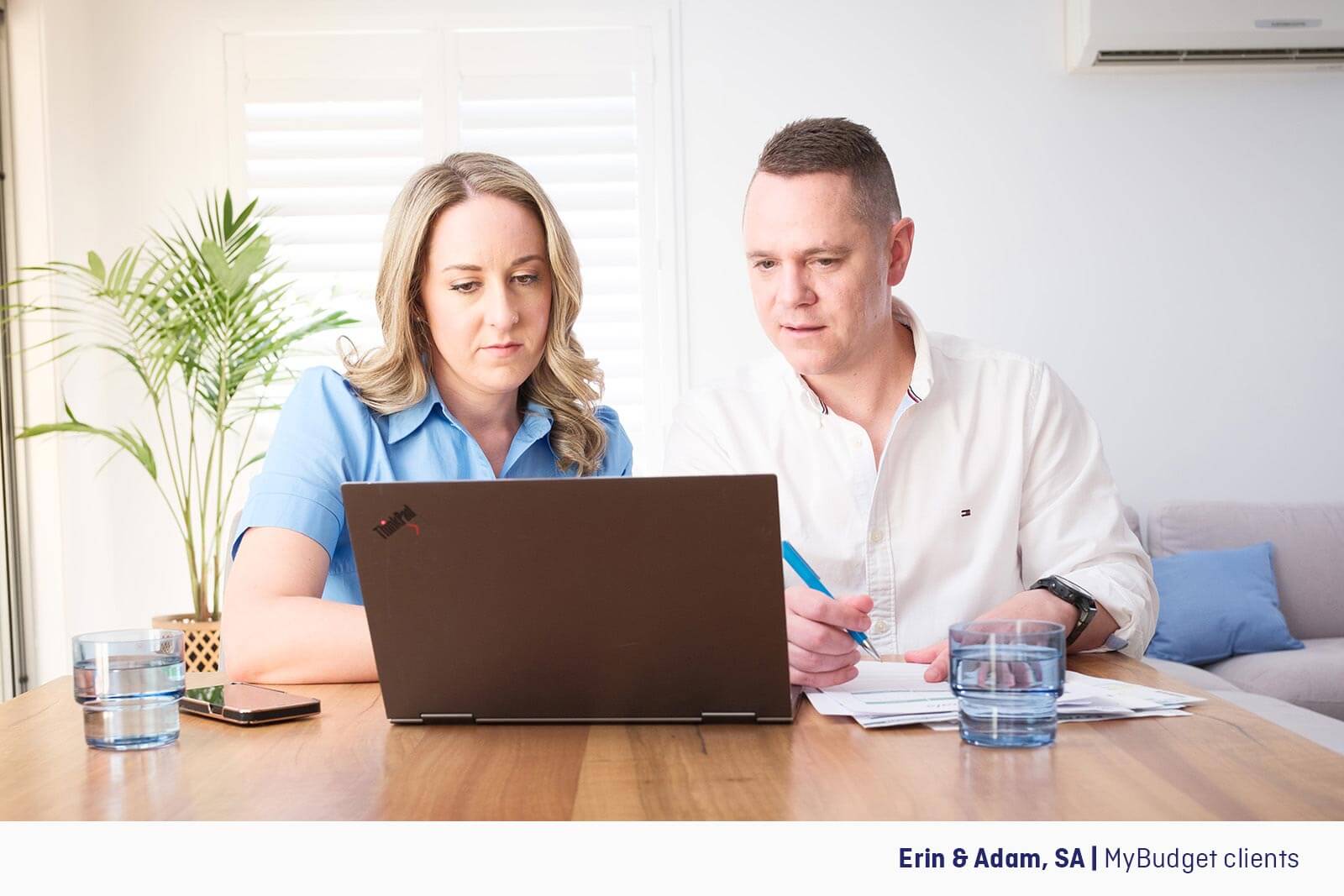 Erin and Adam, MyBudget clients reviewing their budget on a laptop.