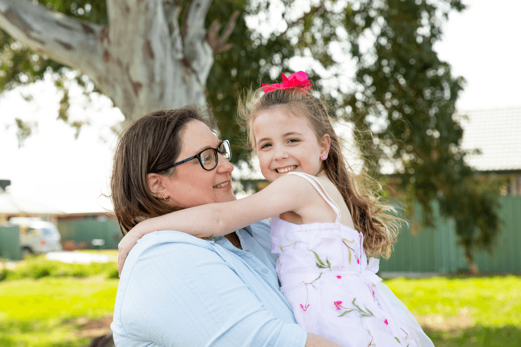 Australian single mum Jenni, a MyBudget client, sharing a happy moment with her daughter after taking control of her finances
