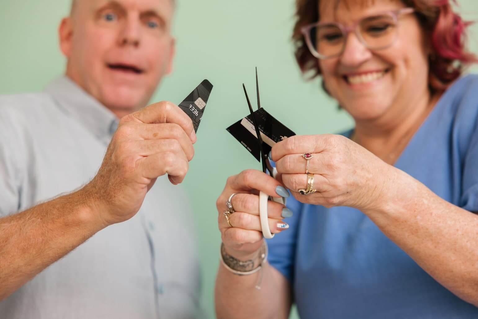 MyBudget clients Michelle and Phil cutting up their credit cards after reducing their debt and reliance on credit with MyBudget.