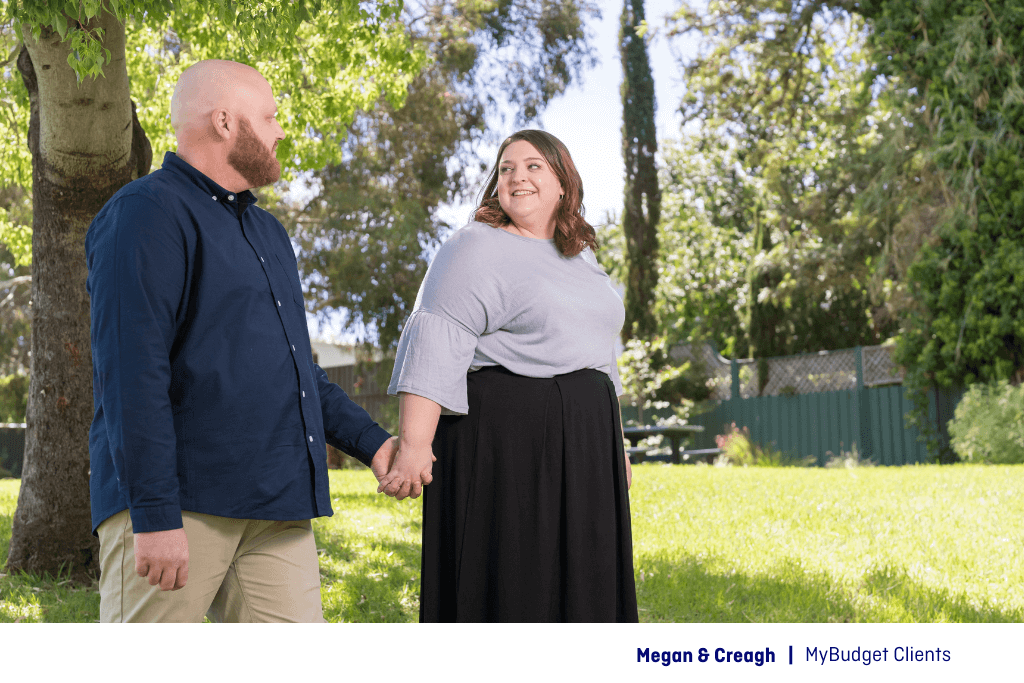 Megan and Creagh walking in the park after paying off debt faster with MyBudget’s help.