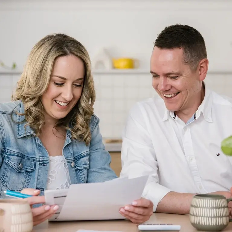 MyBudget clients Adam and Erin organizing bills, supported by a debt management plan and budget planning in Australia.