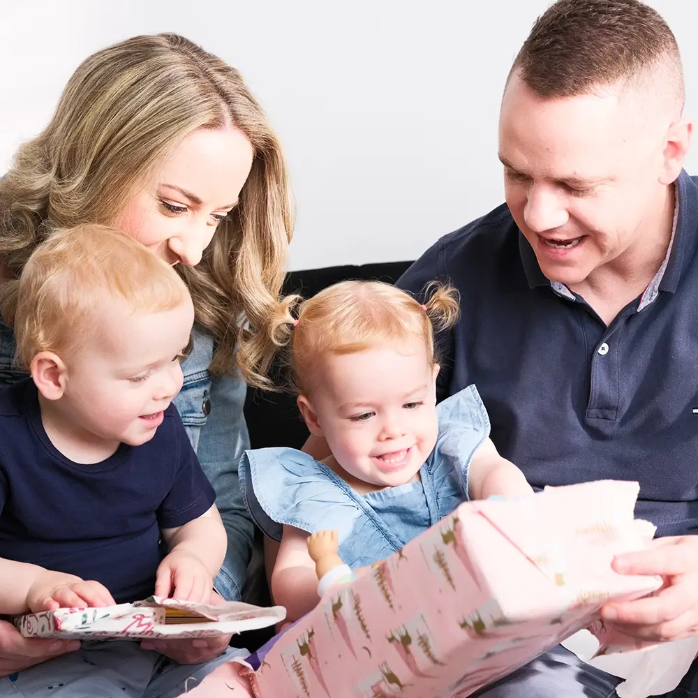 MyBudget clients Adam, Erin, and family enjoying gifts, thanks to successful budget planning and financial goals in Australia.