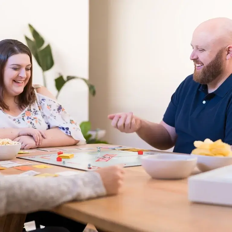 MyBudget clients Megan and Creagh enjoy games nights after finding debt relief after paying off five credit cards in 10 months with personalised debt help and budgeting support in Australia.