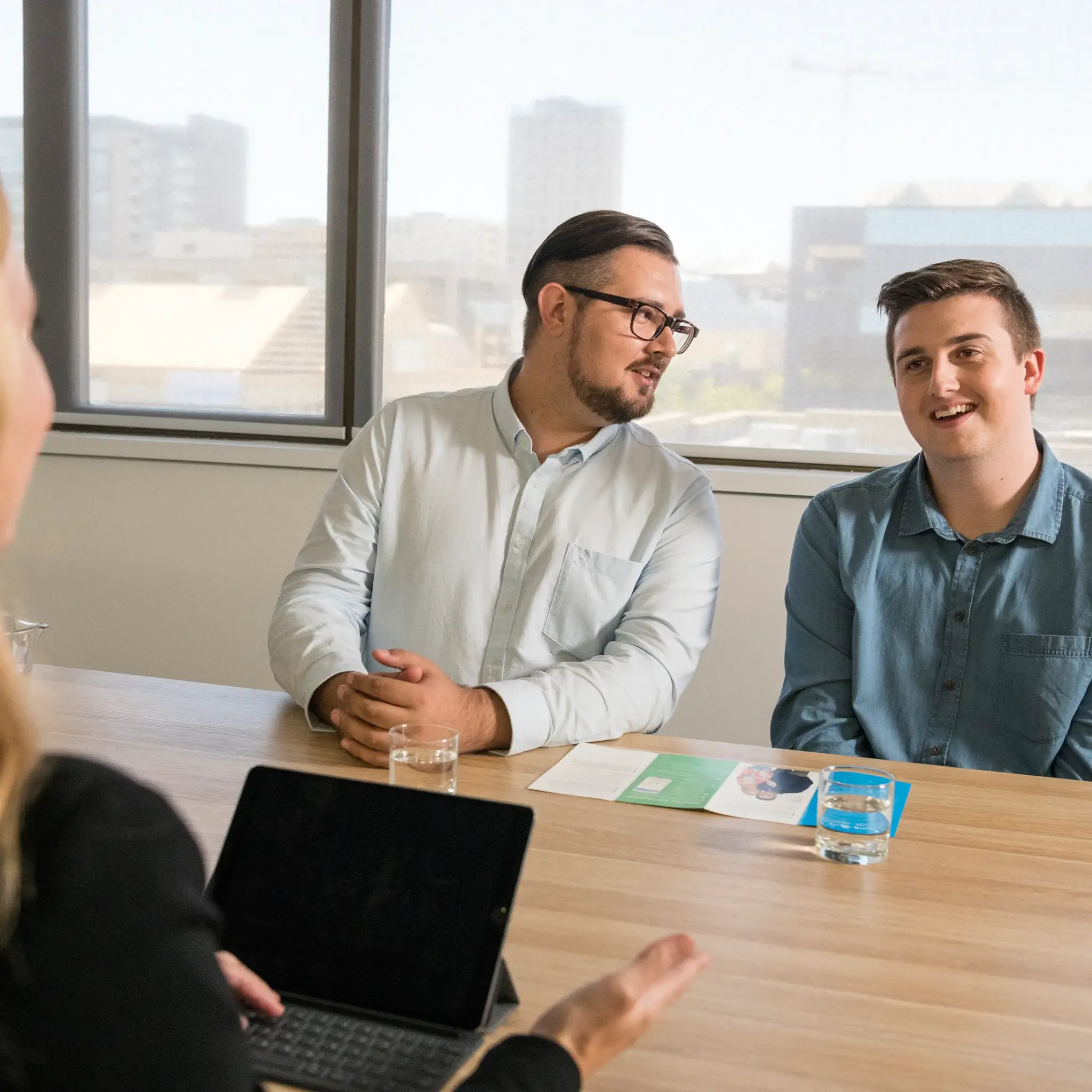 MyBudget clients Aaron and Jake receiving financial coaching during an appointment for debt solutions and budget planning in Australia.