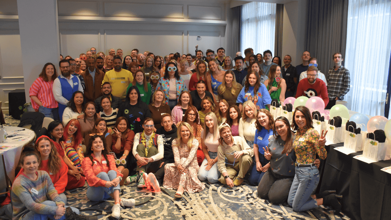 Around hundred MyBudget team staff gathered for their annual Purpose Day, celebrating their mission to make a difference for clients. This large group photo shows smiling employees and leaders, with some in costume, emphasising a strong, cohesive company culture and team excellence at MyBudget.