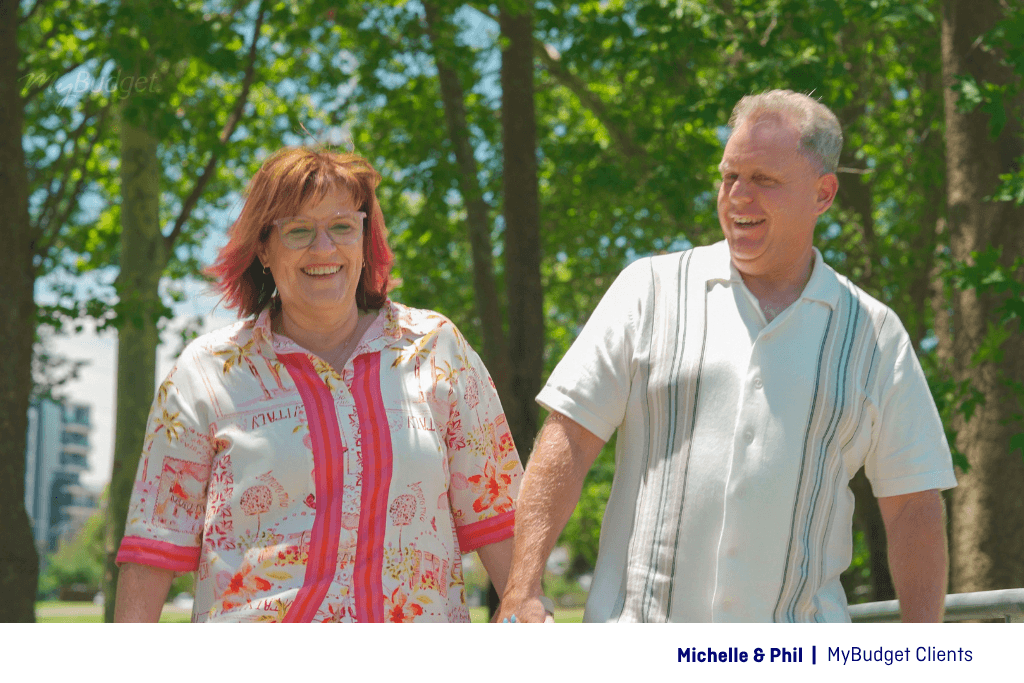 MyBudget clients Michelle and Phil walking through a park while planning for retirement