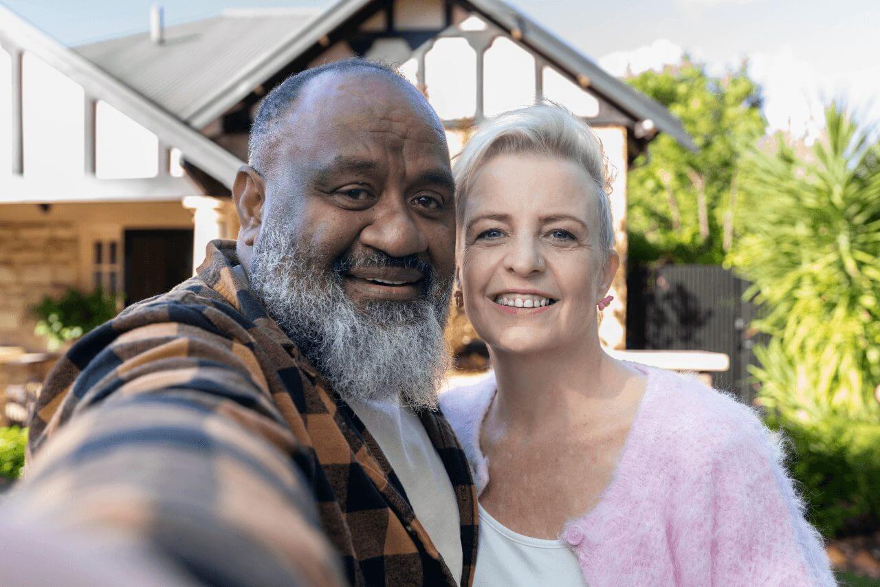 MyBudget clients Kim and Bob smiling together outdoors