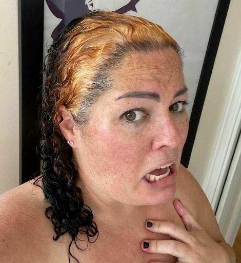 A woman taking a selfie after her hair dye job goes wrong