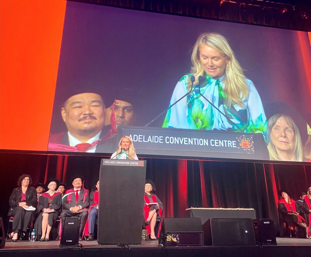 Tammy Barton giving a speech at the Adelaide Convention Centre, addressing AIB MBA graduates about the messy middle parts of life.