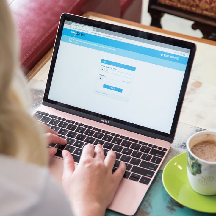 Female logging into MyBudget on her computer