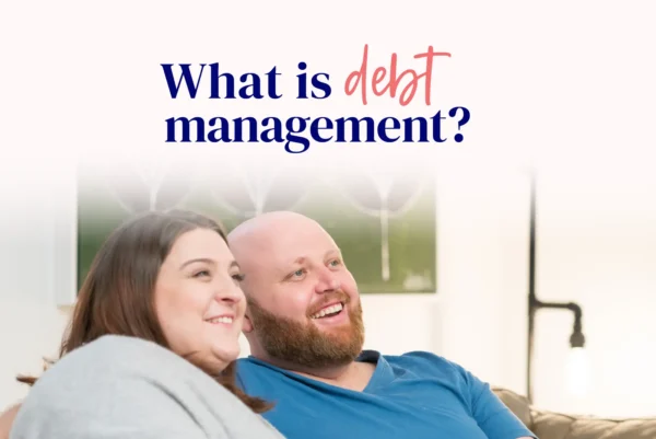 An image titled "What is debt management?" features a happy couple, suggesting a positive outcome from managing debt effectively. The image conveys a sense of relief and confidence, aligning with the idea that debt management helps individuals or couples take control of their financial situation.