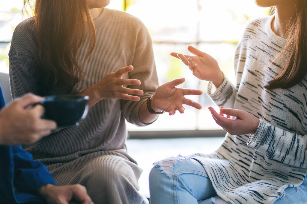 View of people’s hands gesturing to each other as they speak