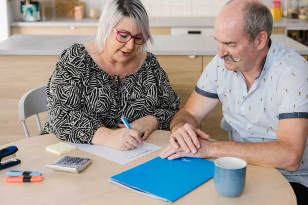 MyBudget clients Kylie and Scott review financial documents, working on strategies to clean their credit report and repair their credit score.