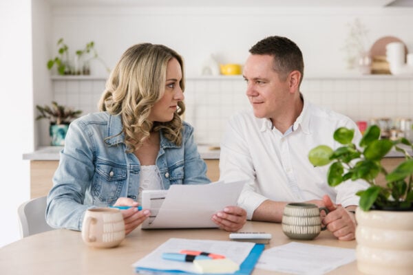 MyBudget clients Erin and Adam sitting at a table, reviewing subscriptions