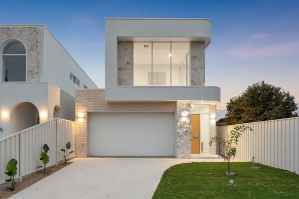 Modern Australian home by MyHomeBuild at sunset, symbolising mortgage savings from RBA interest rate cut and a free home loan health check from MyBudget Loans.